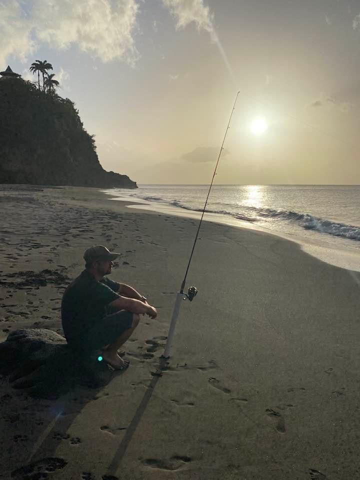 Brad waiting on the setting sun on the beach in Montserrat.