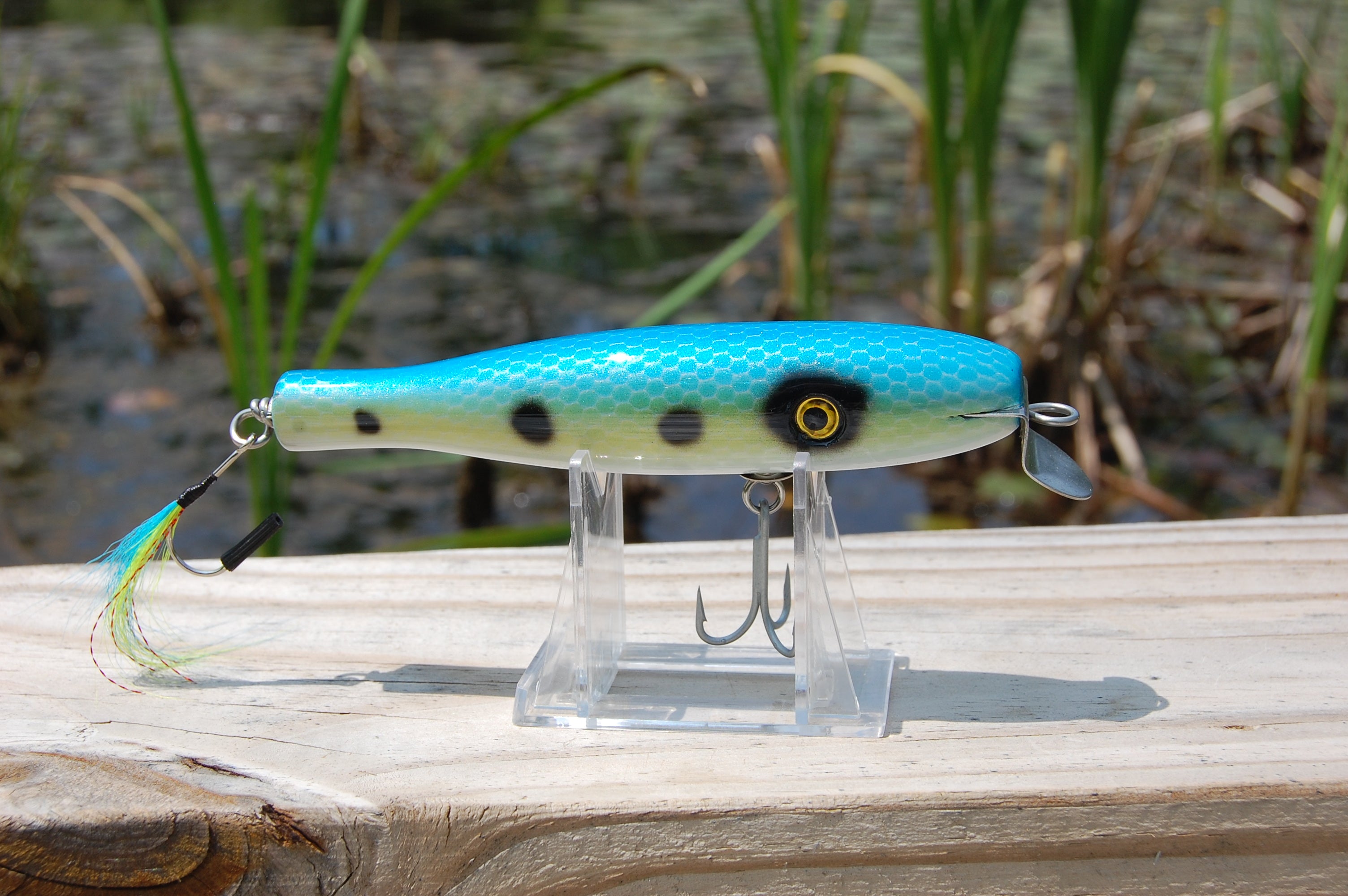 Bass lure painted in a blue and gold shad pattern with scales. Plug is 5.25" long.