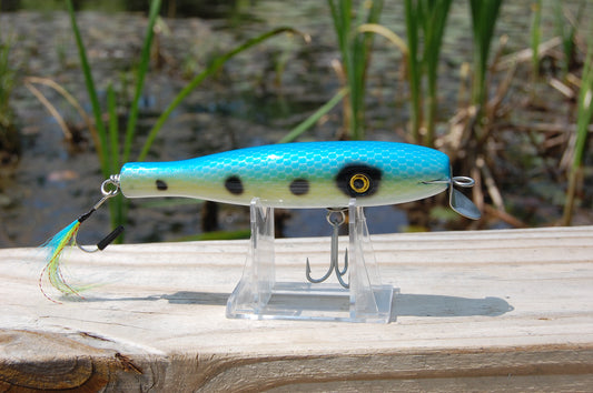 Bass lure painted in a blue and gold shad pattern with scales. Plug is 5.25" long.